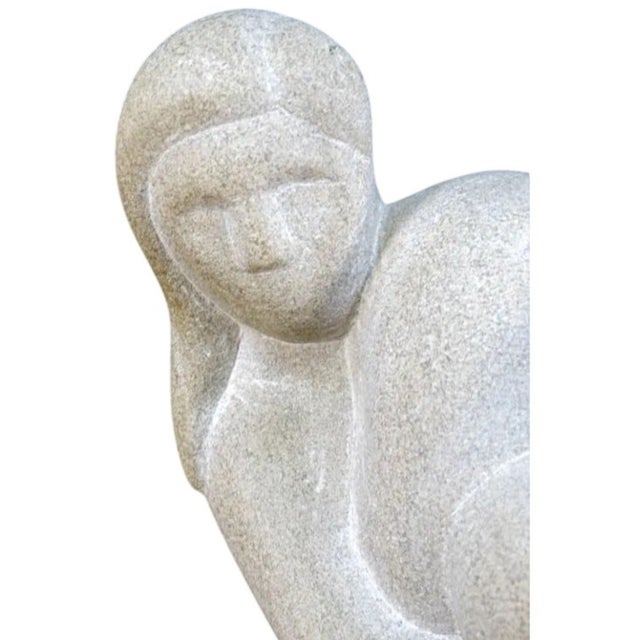 Striking hand-carved stone sculpture of a reclining female nude, rendered in a beautifully simplified, abstract modernist...