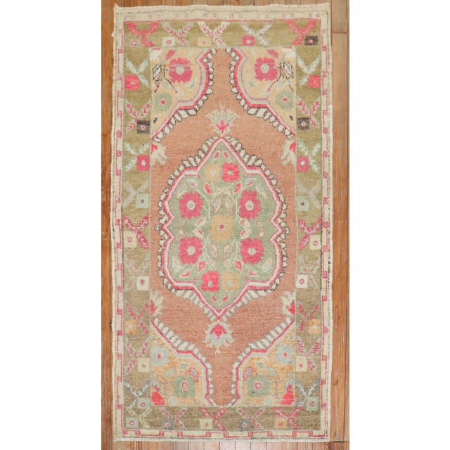 A colorful mid-20th-century Turkish throw-size rug Measures: 2'8'' x 4'11''.