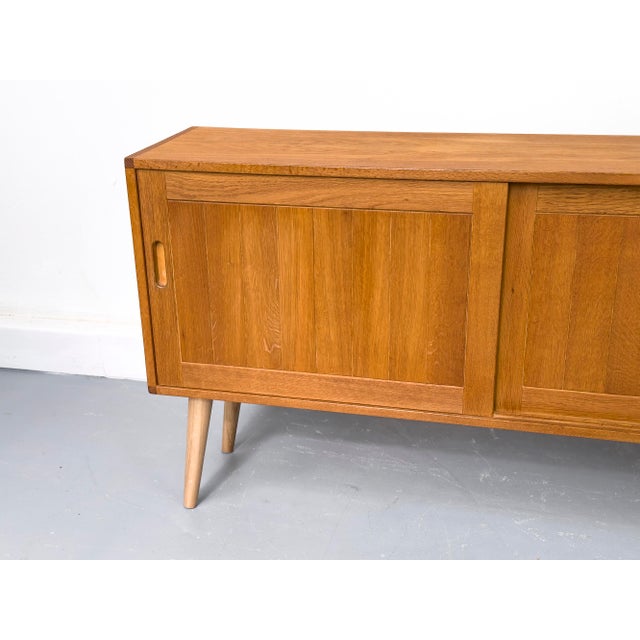 A high-quality cabinet crafted from oiled oak with a warm, natural appeal. The two sliding doors, with their distinctive...