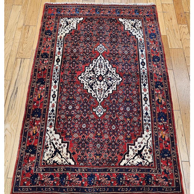 "An exceptional early 20th century vintage Persian Bidjar rug, finely handwoven with a striking Herati field design and a...