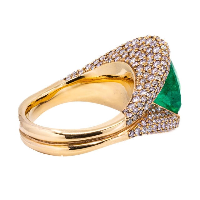 18k Rose gold ring with one pear shape Colombian Emerald weighing 4.52 carats and 2.36 carats of pave set round diamonds....