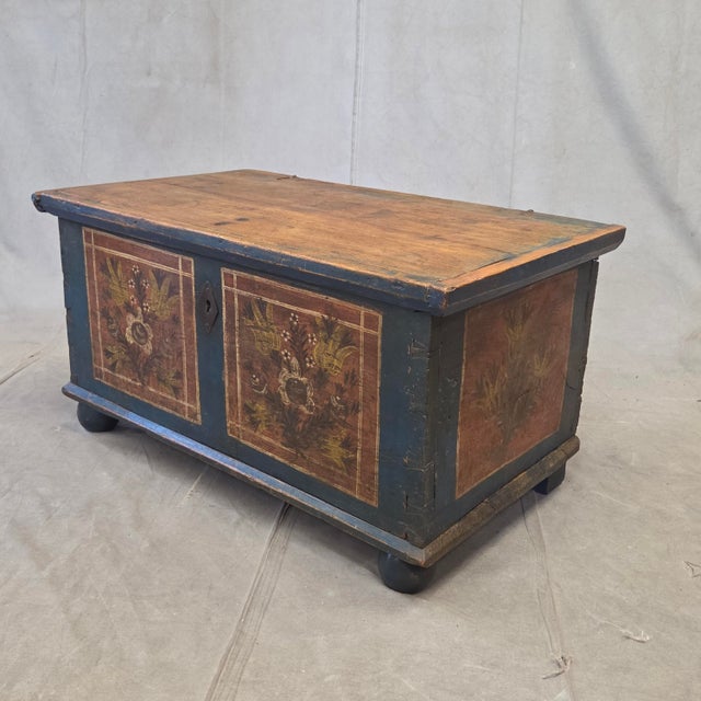 An absolutely charming mid to late 1900s antique German or Austrian blanket chest with the original paint. The base of the...