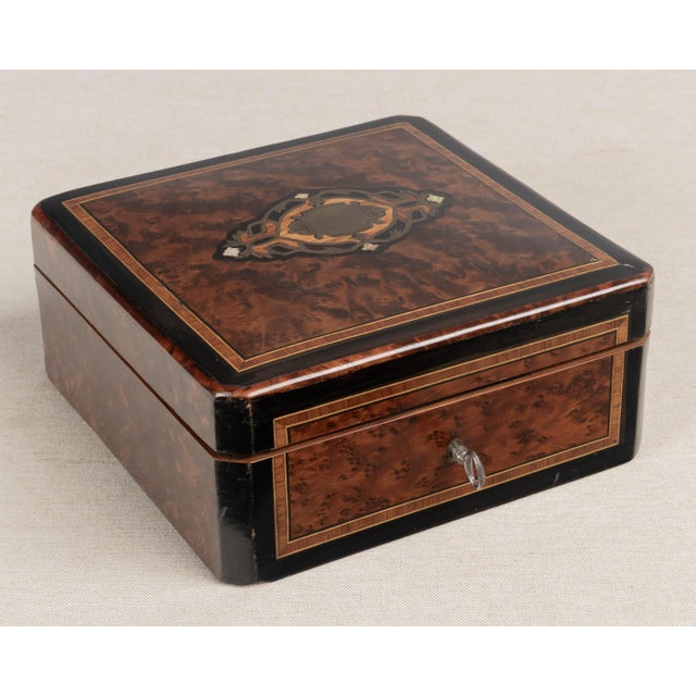 A 19th Century French Napoleon III marquetry box, hand-crafted of walnut and burl veneers with ebonized trim. Fine mother-...
