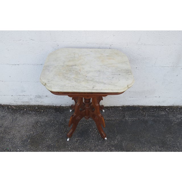 This gorgeous Side Table is made out of wood, solid wood, walnut, veneer, and marble. The End Table has Victorian Eastlake...