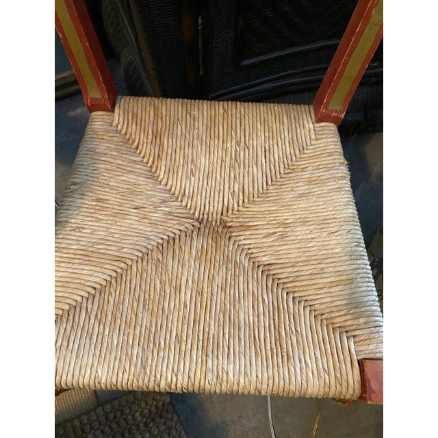 Vintage French red and gold laque red ladder chair with hand woven natural straw seat. Made in France.