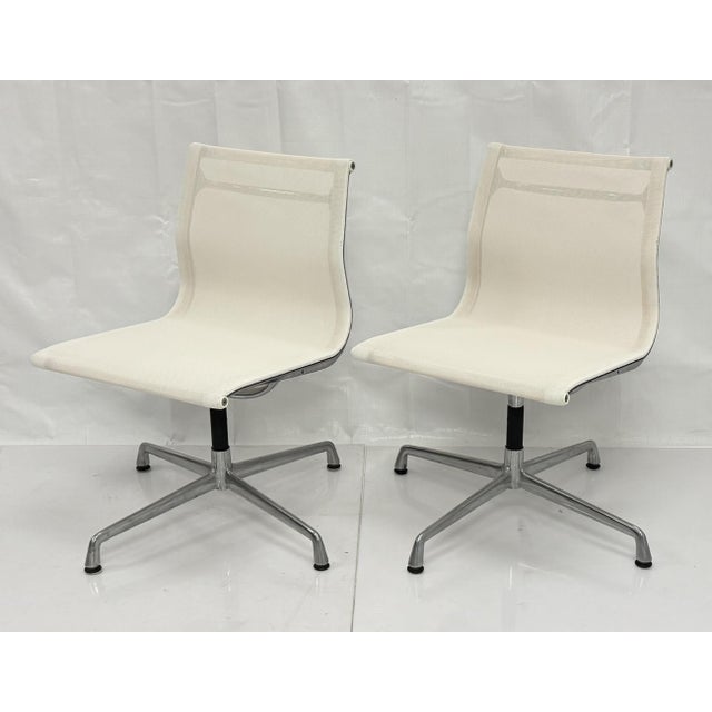 A sophisticated pair of Eames Aluminum Group swivel chairs, the celebrated mid-century modern seating design by Charles...