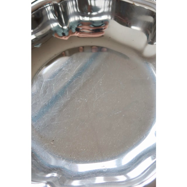 Large silver-plated metal bowl by Guy Degrenne, with a delicately crafted scalloped rim. Its elegant shape and raised...