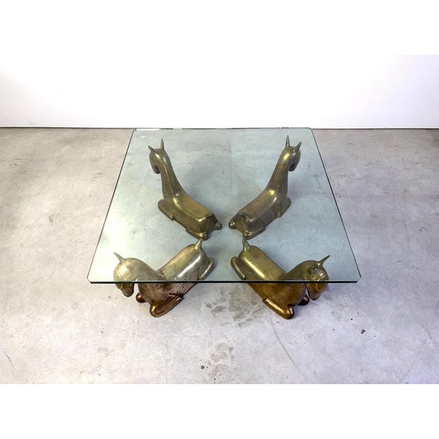 Eye catching and cute brass foal sculpture coffee table with a clear glass top. The sculptures are minimalistic and...