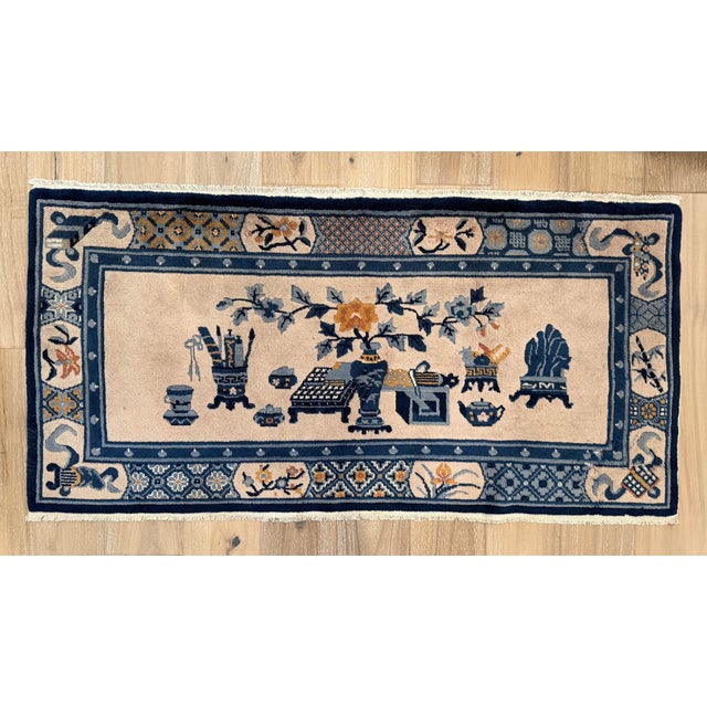 Hand-knotted Chinese Art Deco rug, circa 1920s-1940s, with a pictorial design depicting scholar’s objects, floral...