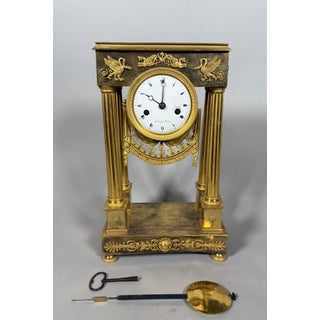 Bronze portico clock from the Empire period, 19th century For Sale