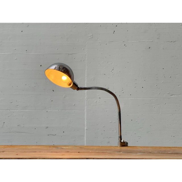 A functional yet distinctive clamp lamp made of chrome-plated metal in the typical space age design of the 1970s. The...