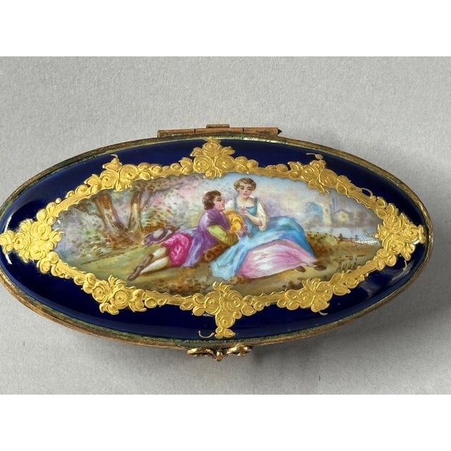 This elegant circa 1860 French Sèvres porcelain trinket box is a refined example of 19th-century French decorative art....