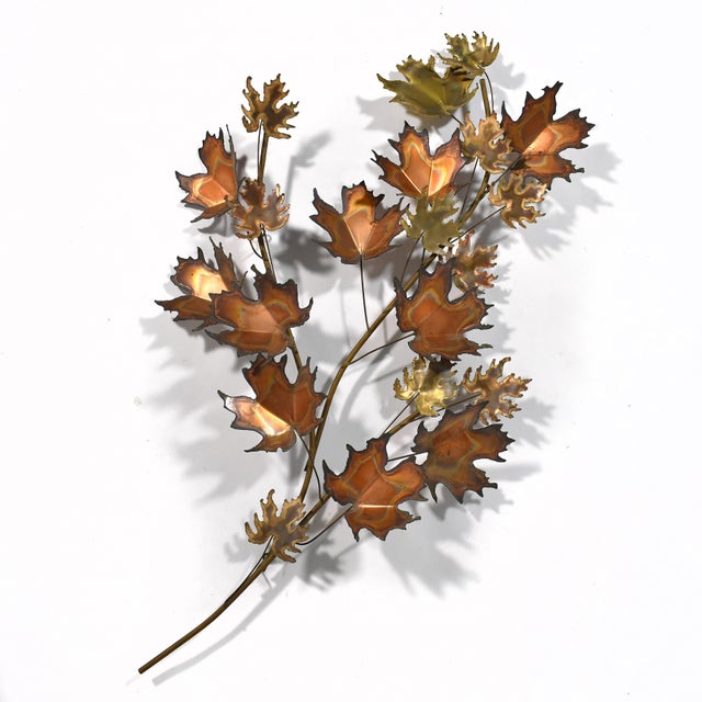 With a delightful autumnal touch, this dynamic composition of textured leaves in mixed metals by C. Jeré activates any...