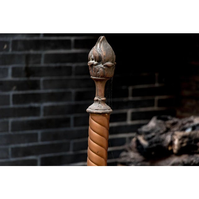 Magnificent 19th-century wrought-iron andirons featuring proud griffins at the base and elegant torch-shaped finials...