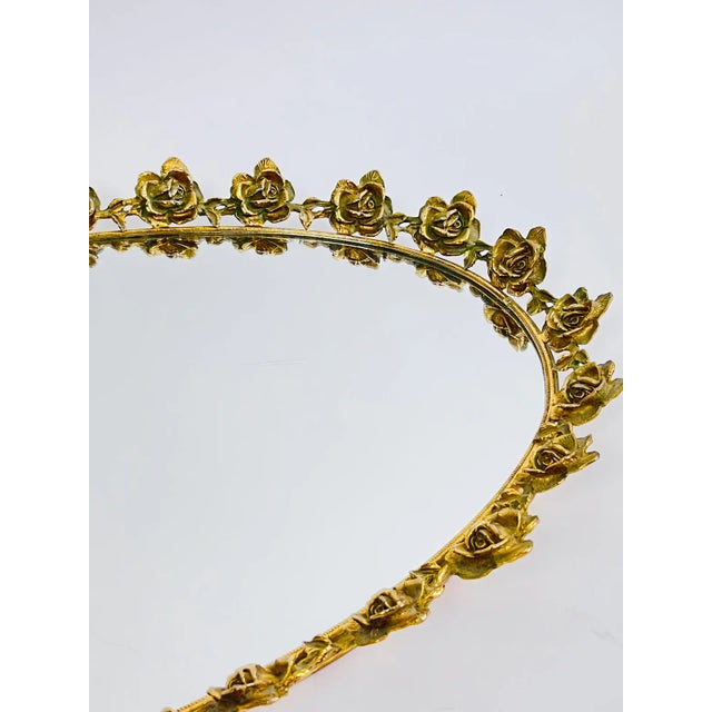 A beautiful large mirror tray within a toned rose filigree surround. Perfect for organizing your bar or dresser.