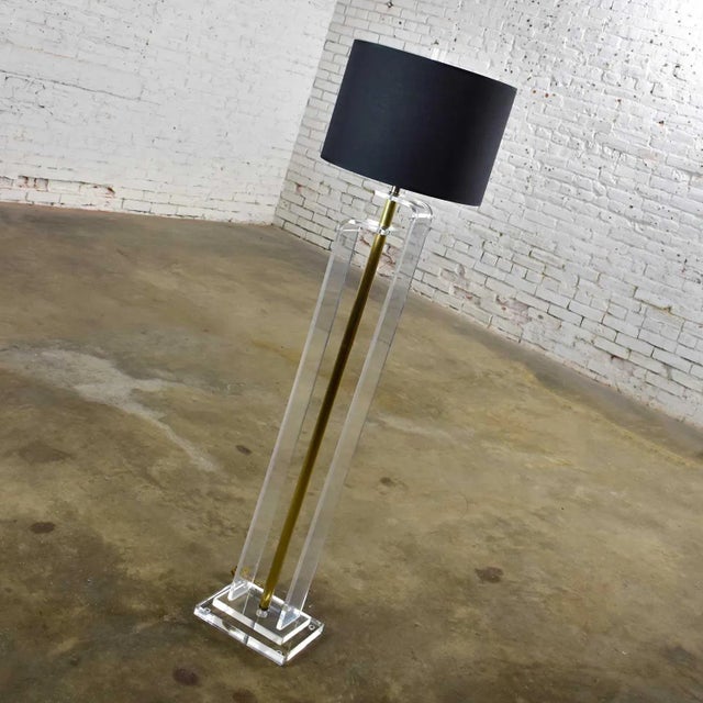 Handsome Art Deco Revival or Hollywood Regency floor lamp comprised of solid Lucite, brass plated shaft, a new black...