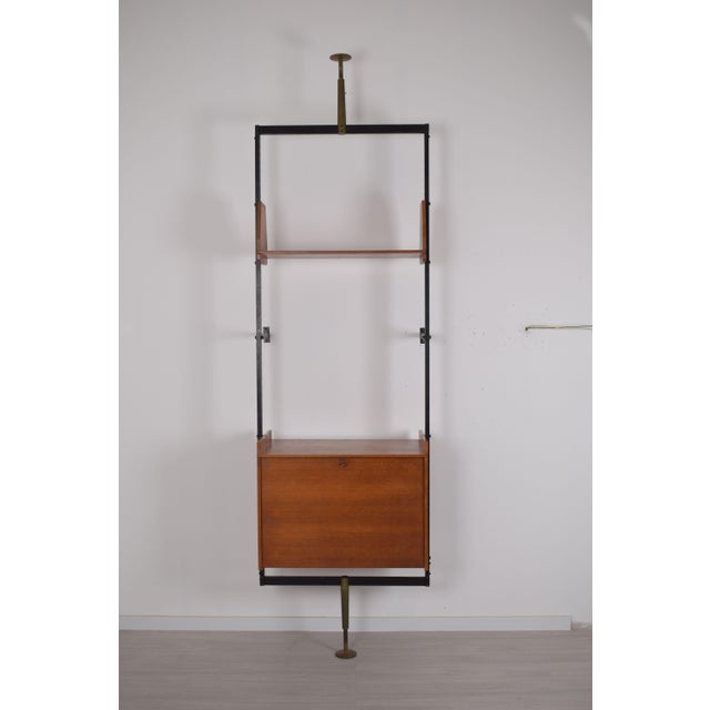 A free-standing bookcase from a 1960s Italian manufacturer, featuring a simple, functional design typical of the period's...