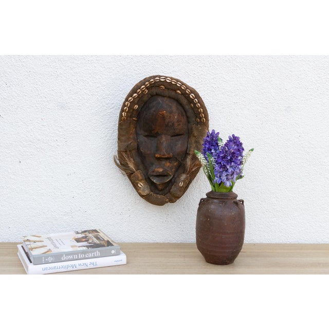 This enigmatic Dan mask from the Ivory Coast is a captivating example of African tribal art. The mask is characterized by...