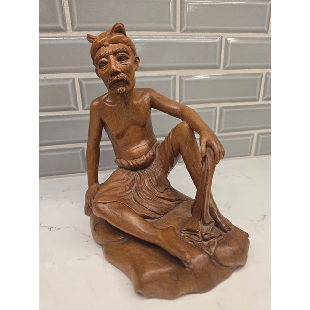 Overview An extraordinary, gallery-grade Mid-Century Balinese modernist portrait sculpture depicting a seated elder or...