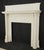 Colonial Revival wood mantle with rectangular frieze panels, a layered cornice shelf, and fluted pilasters. The mantle is...