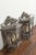 A pair of French iron lanterns from the early 20th century, with three lights and scrolling motifs. Created in France...