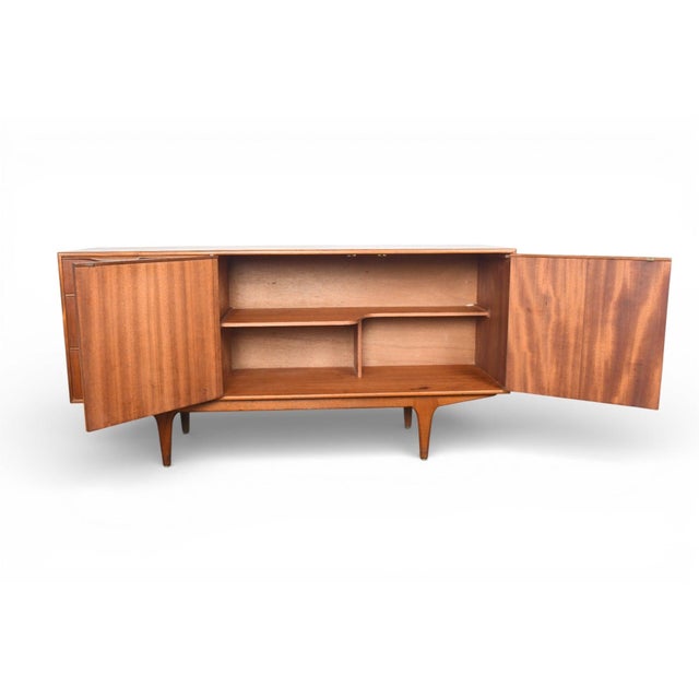 Origin: Scotland Designer: Val Rossi Manufacturer: A.H. McIntosh Era: 1960s Materials: Teak Measurements: 60" wide x 18"...