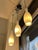 1960s glass pendant lights. Each fixture features three satin white opaline glass diffusers, enhanced by brass details at...