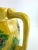 Vintage Japanese majolica-style pitcher featuring raised strawberry and leaf motifs in a vibrant yellow glaze, set above a...