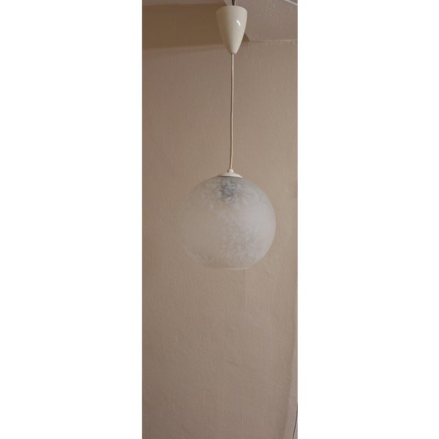 Vintage Ceiling Lamp with Patterned Spherical Shade on a White Bakelite Mount, 1970s, in Very Good conditions. Designed...