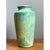 This vase presents a classic, gently tapering silhouette, its cylindrical body rising smoothly from a slightly narrower...
