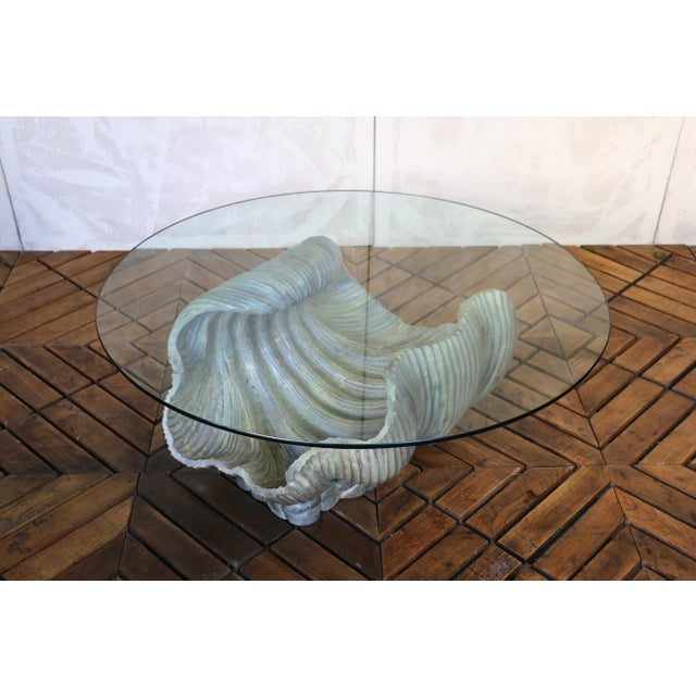 A striking example of Italian craftsmanship, this vintage shell-form coffee table dates to the 1970s and features a...