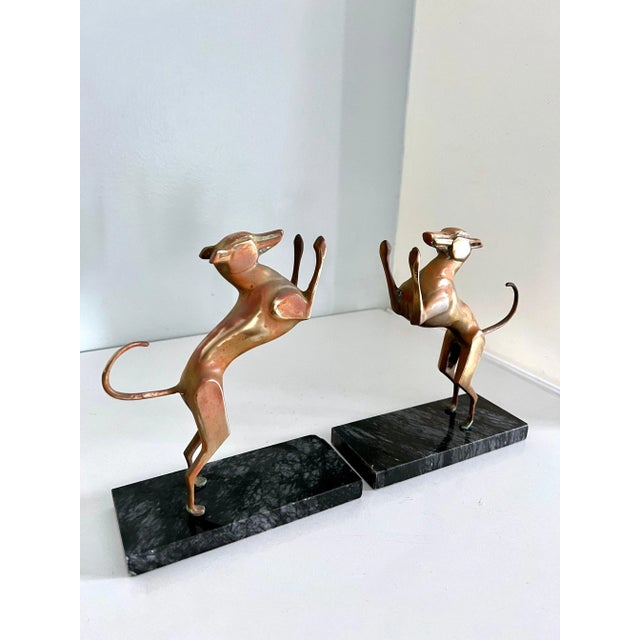 A pair of patinated guard dogs for your books. Marble base steadies the books, so dogs appear to be jumping, rather than...