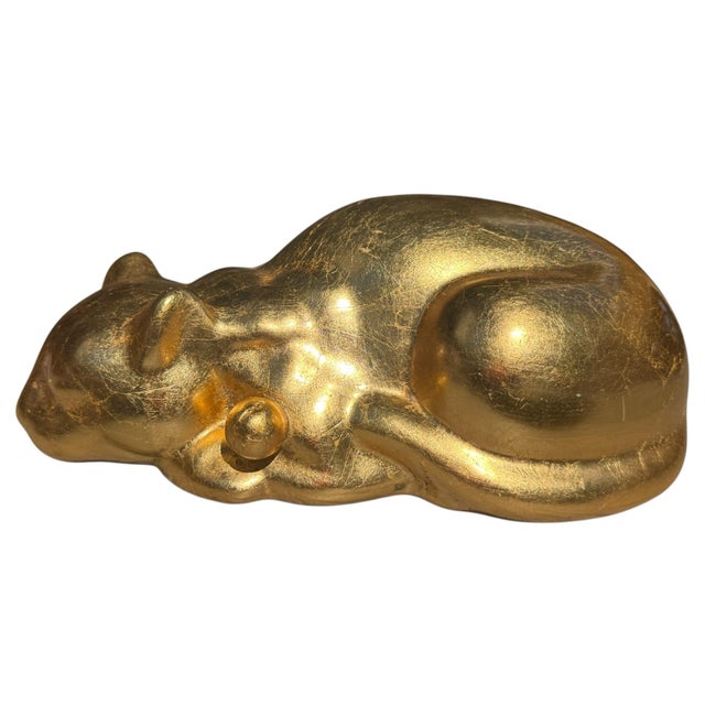 Elegant vintage reclining sleeping cat sculpture with a rich metallic antique-gold finish. The cat is depicted curled...