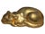 Elegant vintage reclining sleeping cat sculpture with a rich metallic antique-gold finish. The cat is depicted curled...