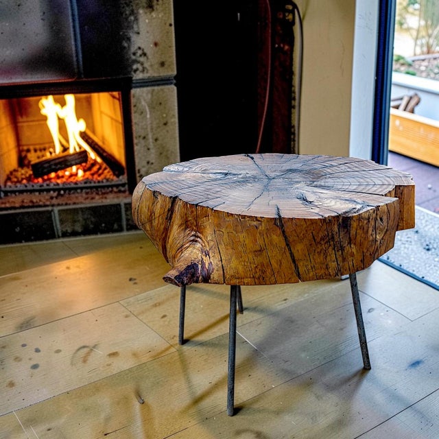 Rustic side table made of reclaimed live edge wood slab top and iron peg legs. The brutalist table top has an asymmetric...