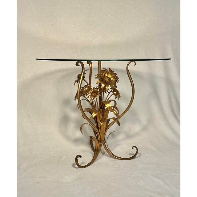 Vintage 1960's Hollywood Regency gold-gilt accent/side table with clear round glass top and floral Tole accent base.