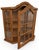 Vintage wall-mounted oak curio cabinet featuring an architectural arched crown, divided transparent panels, angled sides,...