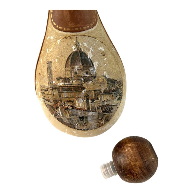 Mid-Century Italian glass decanter wrapped in tooled leather with large wooden ball and plastic twist off stopper....
