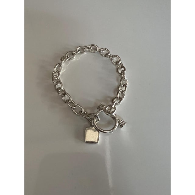 Chunky Sterling Silver Link Bracelet Featuring a Classic Tibetan Toggle Clasp and a Square Heart-Accented Charm For Sale - Image 4 of 6