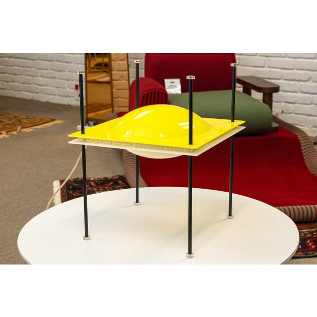 A postmodern space age “UFO Lamp” designed by Ettore Sottsass for Arredoluce, Italy 1957. Molded plastic, enameled brass,...
