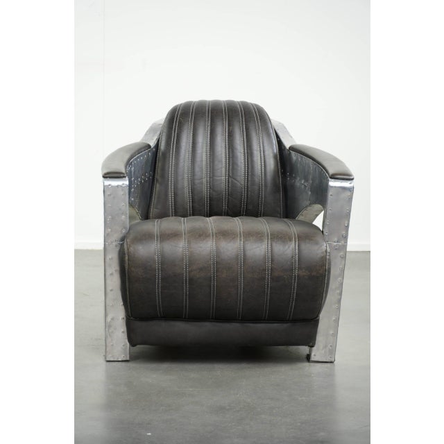 This unique and comfortable Aviator design armchair in cowhide leather features a bold design and is finished with...