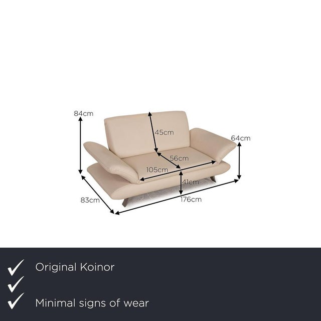 Two-seater Rossini from Koinor is covered with a cream-colored genuine leather and stands on silver metal feet. It is...