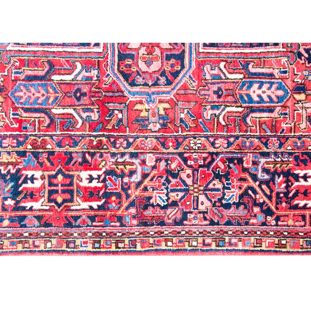 This mid-20th-century Persian Heriz rug showcases the bold, geometric artistry typical of Northwest Iran. A large, multi-...
