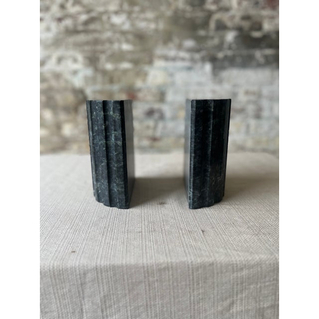 Elevate your bookshelf or desk with this striking pair of solid marble bookends, carved in a sleek fluted design. Crafted...