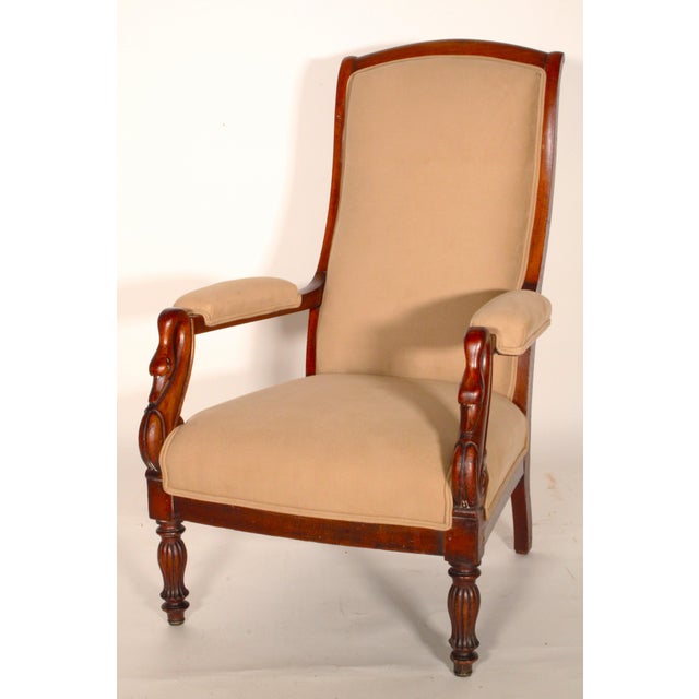 Louis Philippe mahogany armchair, circa 1840. With a scrolled crest rail, upholstered back and seat, swan carved and...