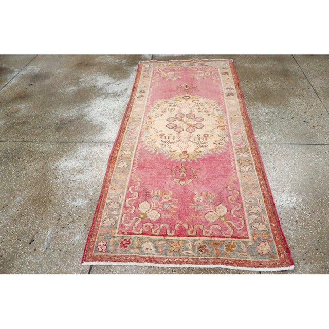 This early 20th century Turkish Oushak rug, showcases the region’s renowned artistry and distinctive use of color. The...