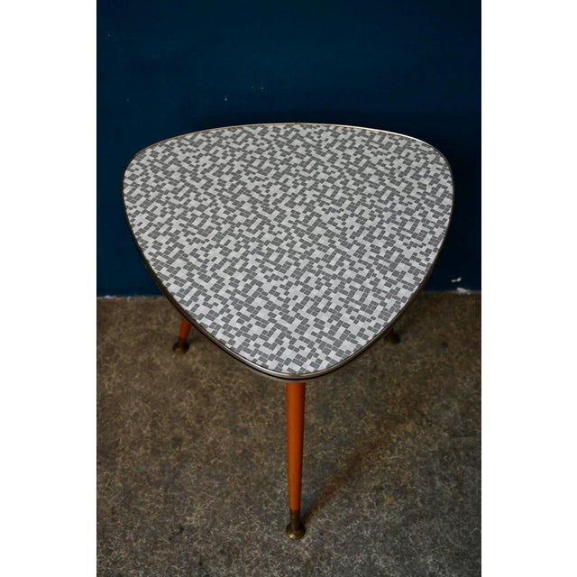 Whether used as a side table, bedside table, or coffee table, this vintage cocktail table features a compass base typical...