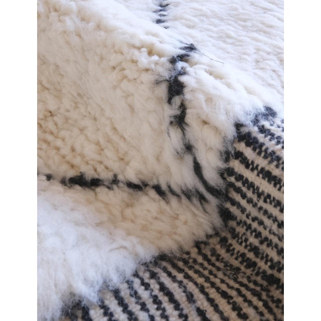 Add a touch of elegance to your space with our Moroccan Beni Ourain Wool Rug. Measuring 9.7 x 7.1 ft, this classic white...
