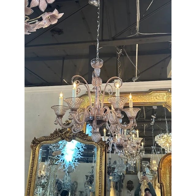 Gorgeous vintage Murano amethyst glass brass twist arm chandelier. Circa 1970. The chandelier has been professionally...