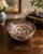 A striking antique Japanese Imari porcelain bowl of generous proportions beautifully hand painted in the traditional Imari...